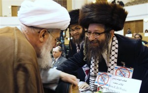 A cleric speaks with U.S. Rabbi Weiss, of the organisation Jews United Against Zionism in Tehran